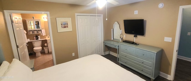 tiled bedroom with a closet, ceiling fan, and ensuite bathroom