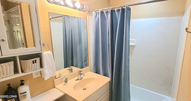 bathroom with shower / tub combo and vanity