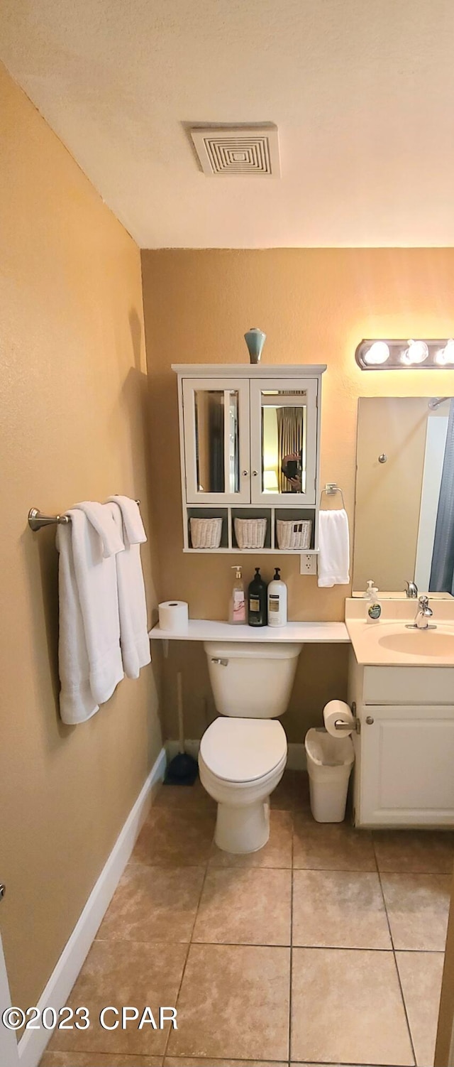 bathroom with vanity, tile flooring, and toilet