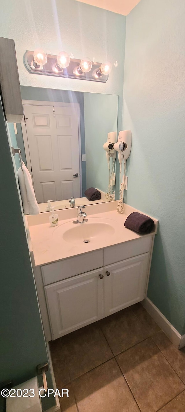 bathroom with vanity and tile flooring