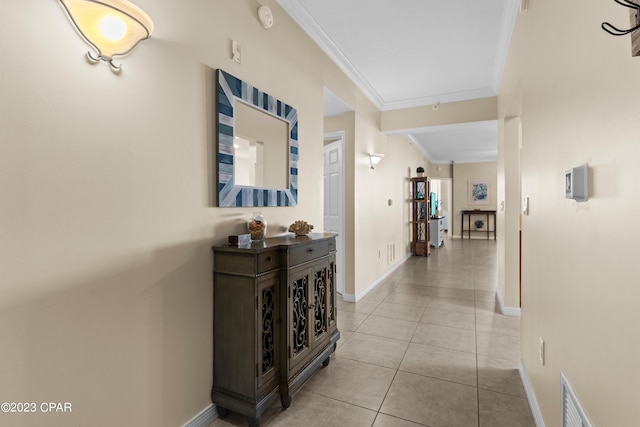 hall with crown molding and light tile patterned floors