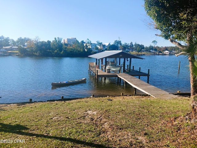 dock area with a yard and a water view