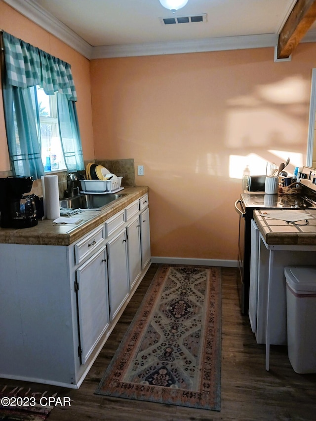 kitchen with electric range oven, crown molding, sink, beamed ceiling, and dark hardwood / wood-style floors