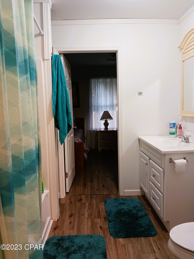 full bathroom with shower / bath combination with curtain, vanity, wood-type flooring, and toilet