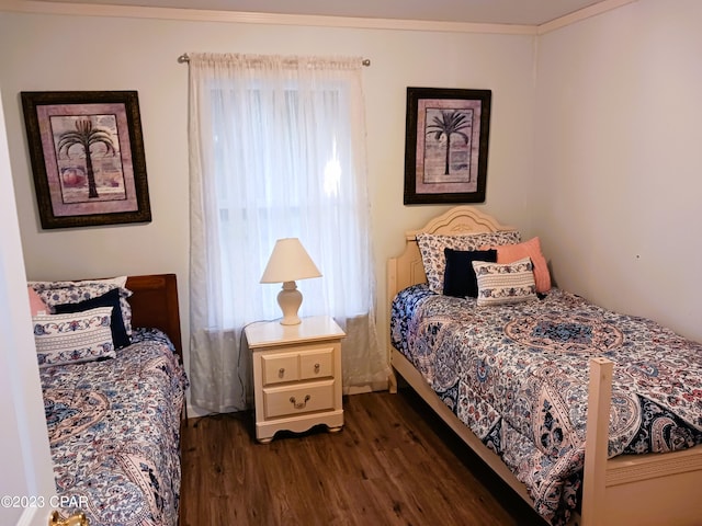 bedroom featuring dark hardwood / wood-style flooring and ornamental molding