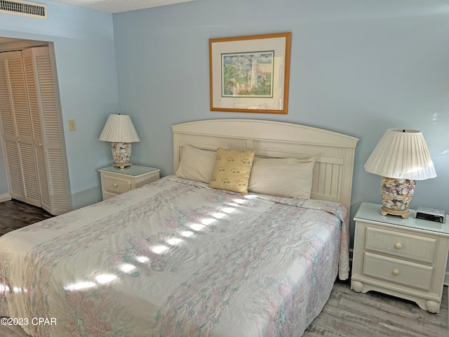 bedroom with light wood-type flooring and a closet