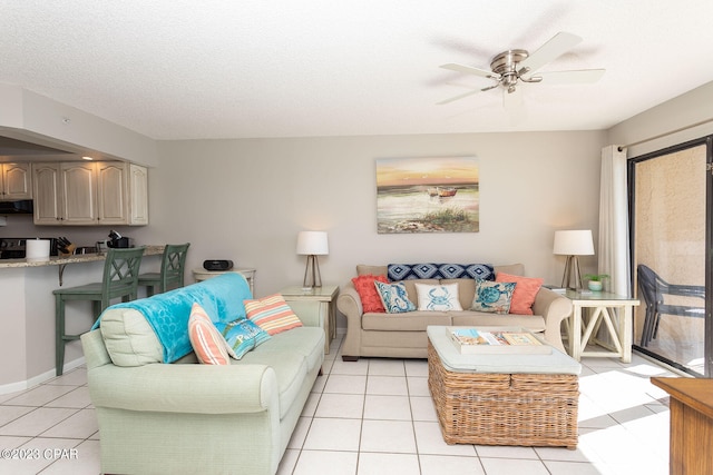 tiled living room with a textured ceiling and ceiling fan