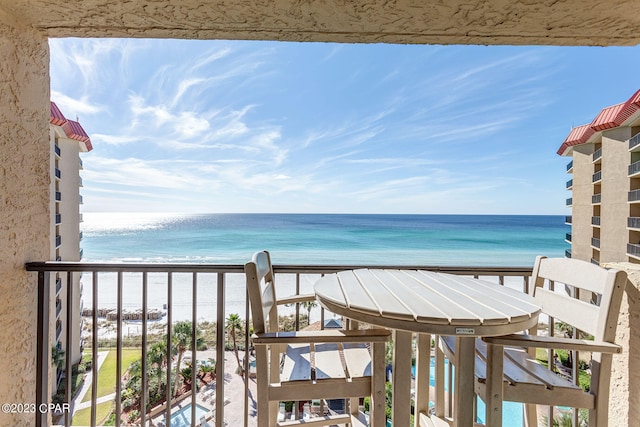 balcony with a beach view and a water view