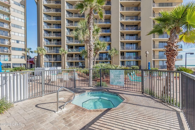 view of swimming pool with a hot tub