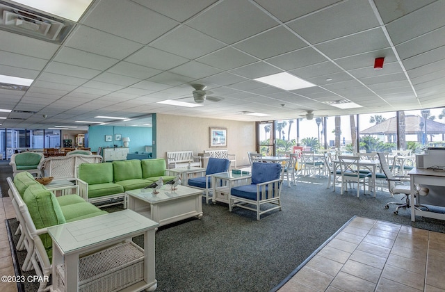 interior space featuring a paneled ceiling and ceiling fan