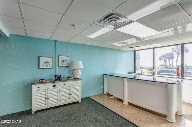 misc room with a paneled ceiling