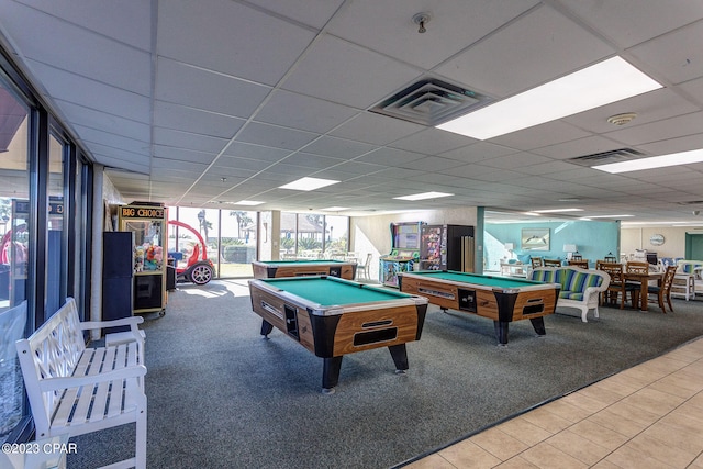 rec room with a paneled ceiling, carpet flooring, a wall of windows, and pool table