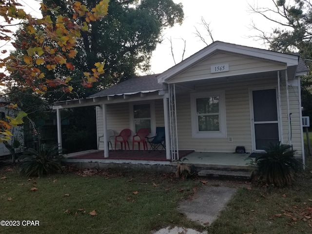 back of property with a porch