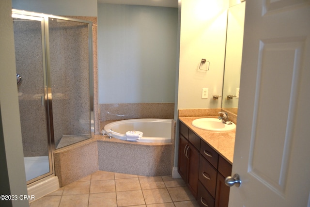 full bath with a garden tub, a stall shower, tile patterned flooring, and vanity