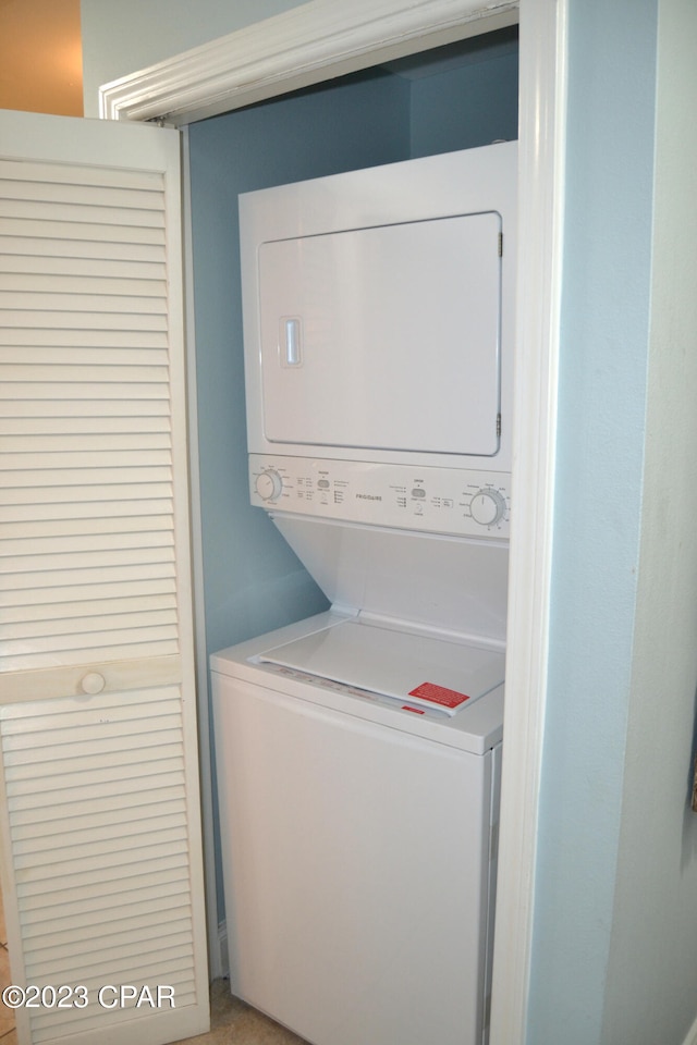 washroom with laundry area and stacked washer / dryer