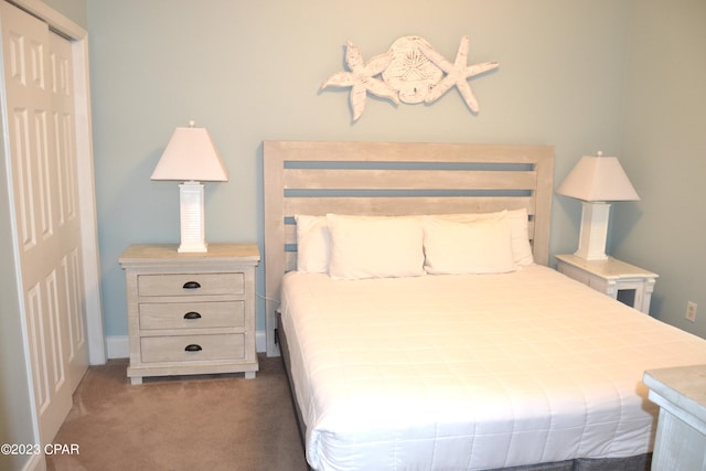 bedroom featuring dark carpet and a closet