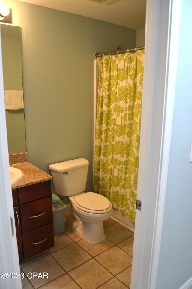 bathroom featuring a shower with shower curtain, tile patterned flooring, toilet, and vanity