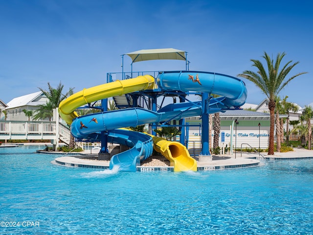 view of swimming pool with a water slide