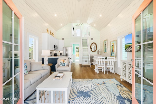 living room with lofted ceiling, wood ceiling, a wealth of natural light, and dark hardwood / wood-style flooring