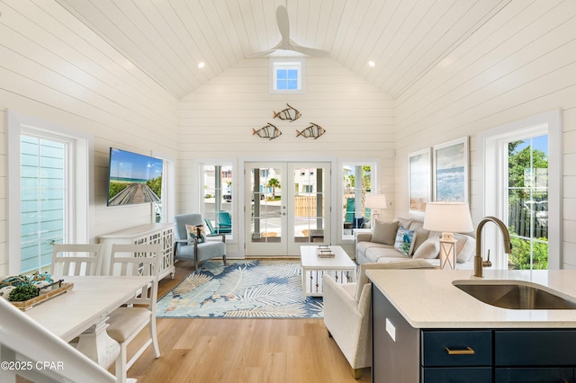 sunroom featuring wooden ceiling, lofted ceiling, french doors, and sink