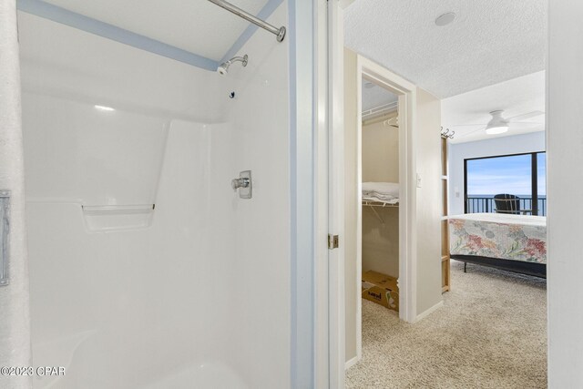 bathroom featuring a textured ceiling and ceiling fan