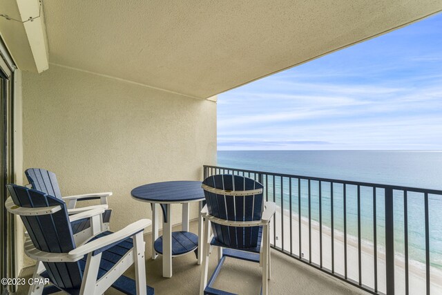 balcony with a view of the beach and a water view