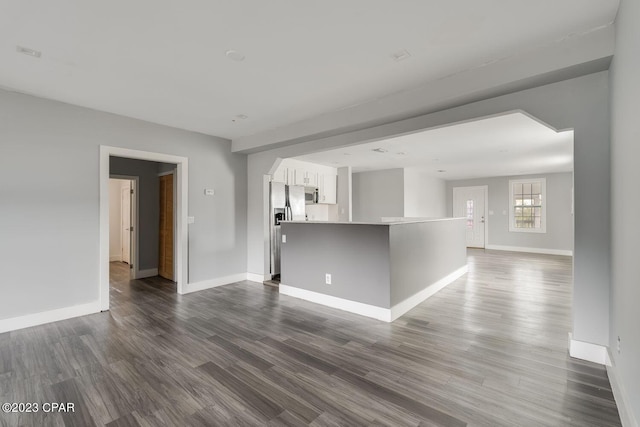 unfurnished living room with dark hardwood / wood-style flooring