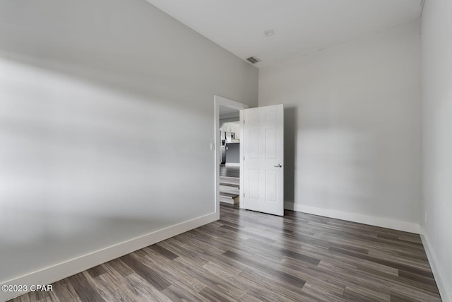 empty room featuring dark wood-type flooring