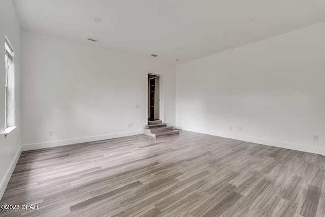 spare room with light wood-type flooring