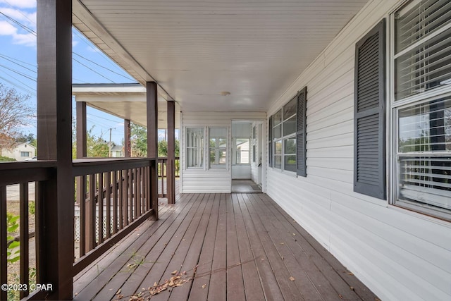 wooden terrace featuring covered porch