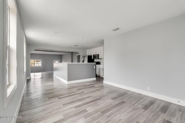 unfurnished living room featuring light wood-type flooring