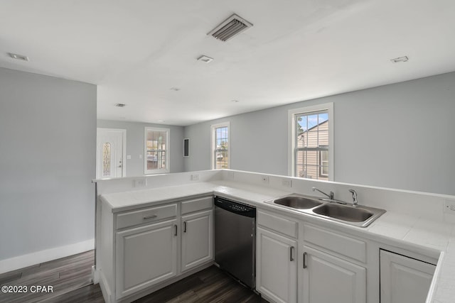 kitchen featuring dark hardwood / wood-style flooring, kitchen peninsula, stainless steel dishwasher, and sink