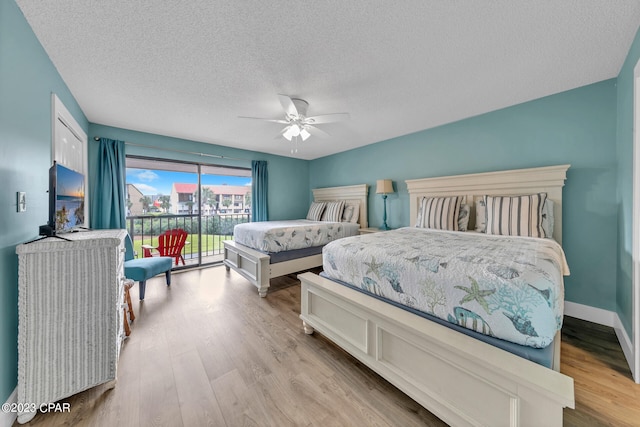 bedroom featuring ceiling fan, access to exterior, light wood-type flooring, and a textured ceiling