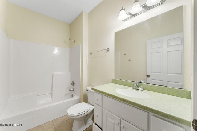 full bathroom featuring toilet, tile patterned flooring, vanity, and tub / shower combination