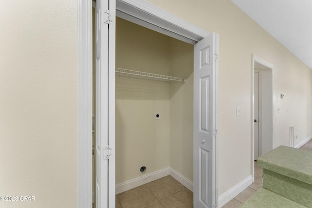 laundry room with light tile patterned flooring and hookup for an electric dryer