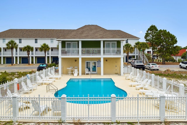 view of pool featuring french doors and a patio area