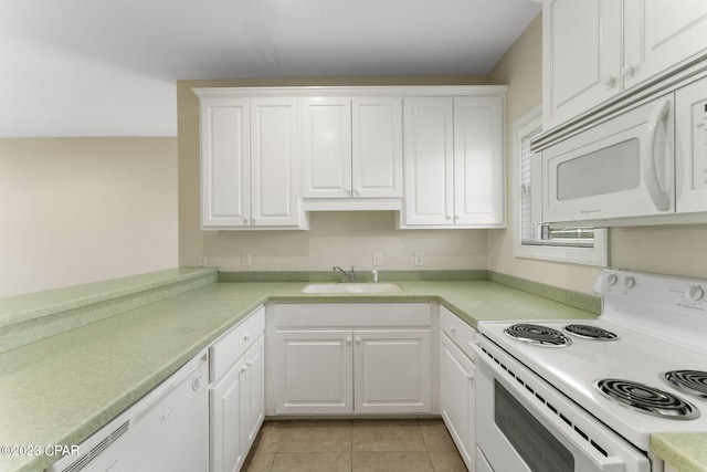 kitchen featuring light tile patterned flooring, white appliances, white cabinetry, and sink