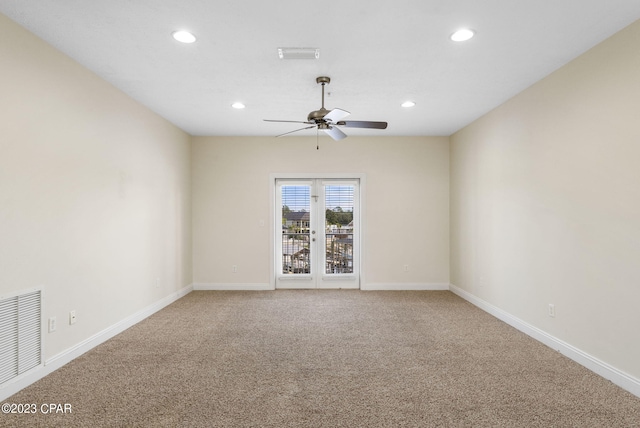 carpeted empty room with ceiling fan and french doors