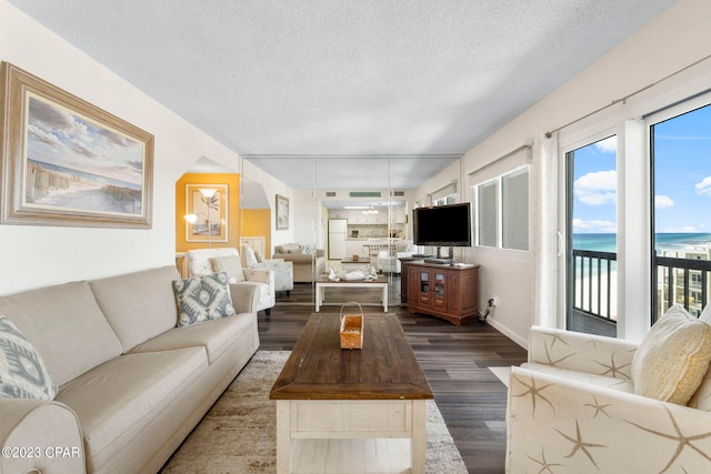 living room featuring dark hardwood / wood-style floors and a textured ceiling