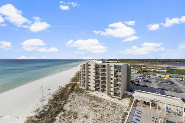 drone / aerial view with a water view and a view of the beach