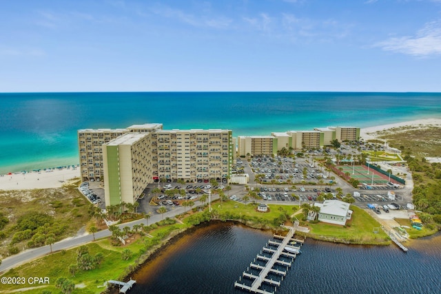 drone / aerial view featuring a water view and a view of the beach