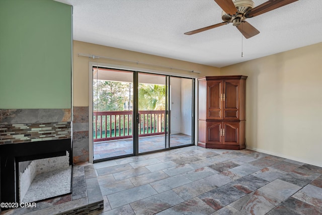 interior space with tile patterned floors, a textured ceiling, and ceiling fan