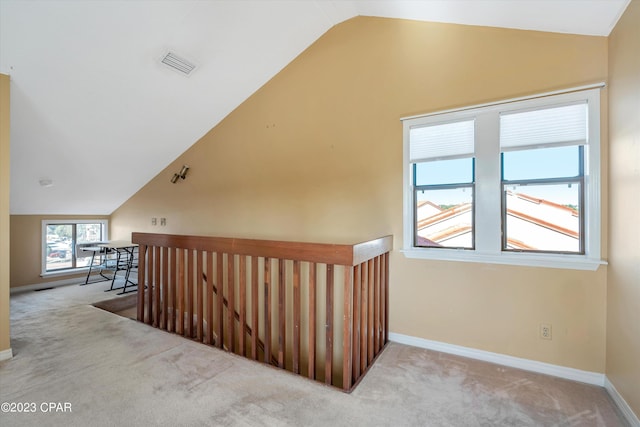 staircase with vaulted ceiling and light colored carpet