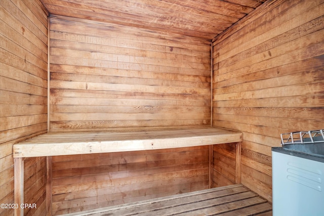 view of sauna / steam room featuring wood walls and wooden ceiling