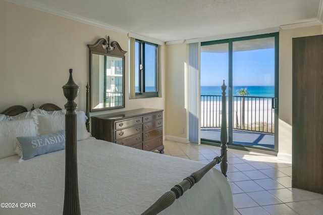 bedroom with access to exterior, a textured ceiling, crown molding, light tile patterned floors, and a water view