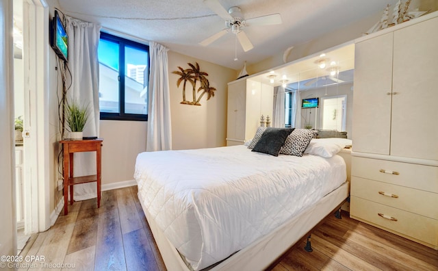 bedroom with light hardwood / wood-style floors and ceiling fan