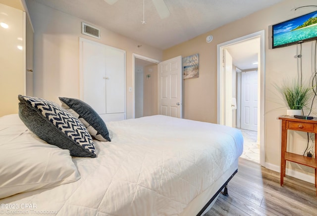 bedroom with ceiling fan and light wood-type flooring