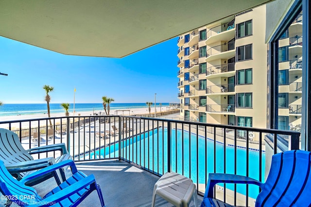 balcony featuring a water view and a view of the beach