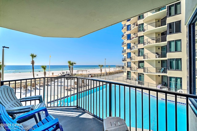 balcony featuring a water view and a view of the beach