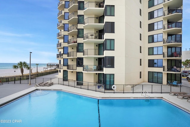 view of swimming pool with a water view